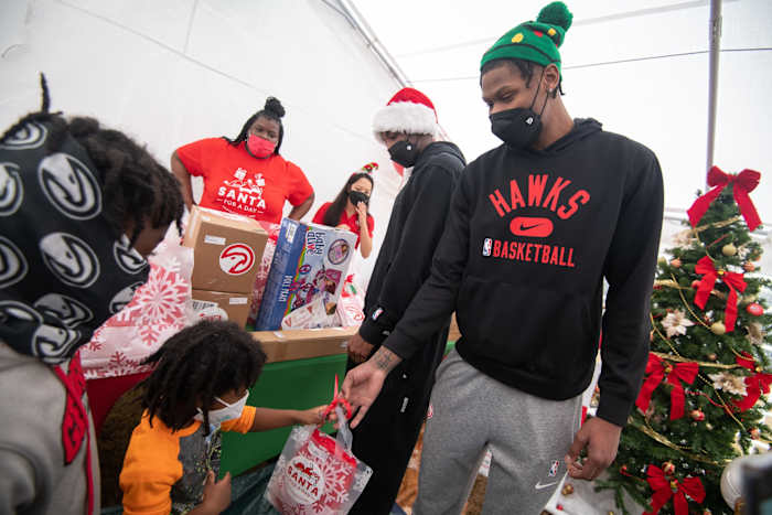 Atlanta Hawks players distribute 1,500 gifts to underserved youth on December 18, 2021.